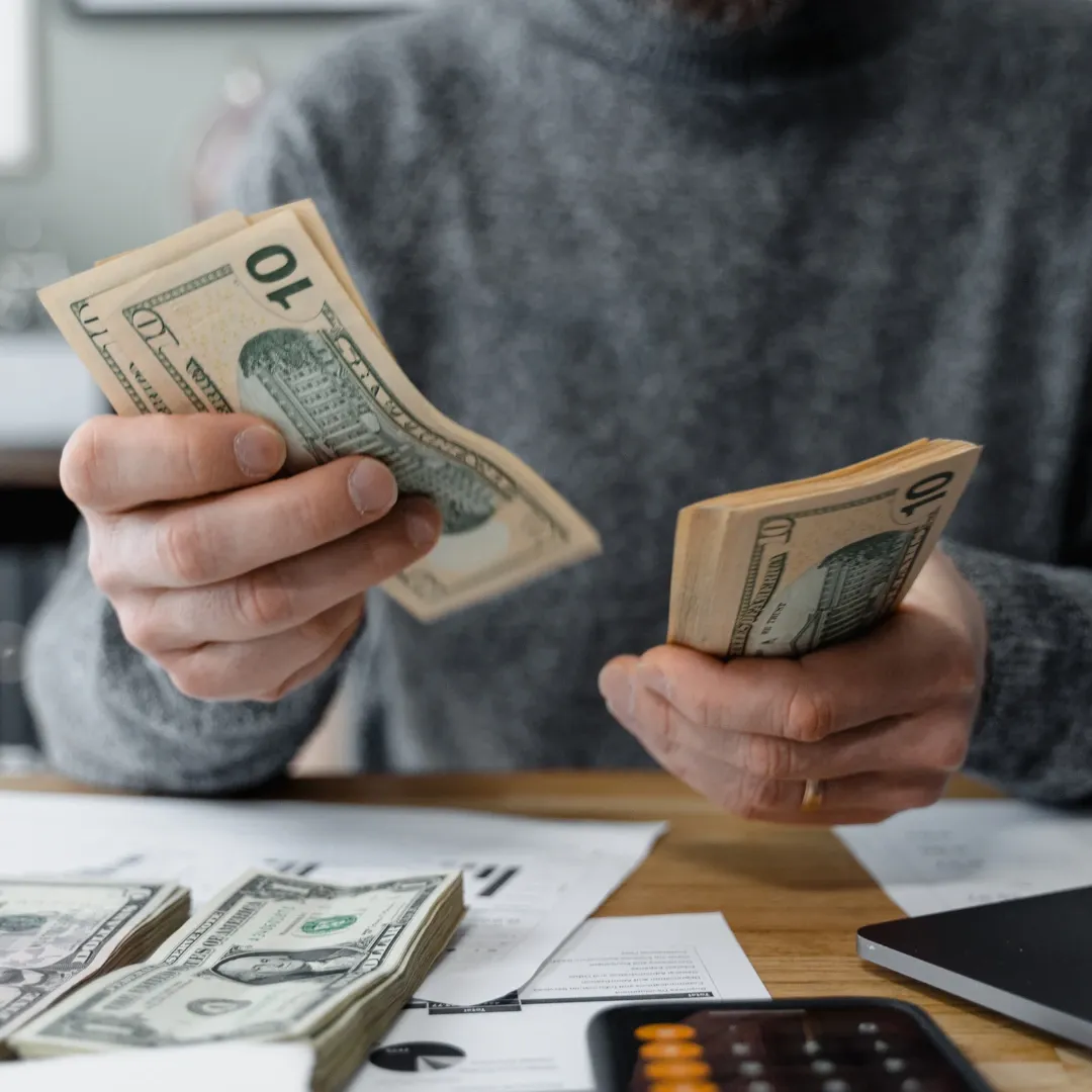 Older man holding money.