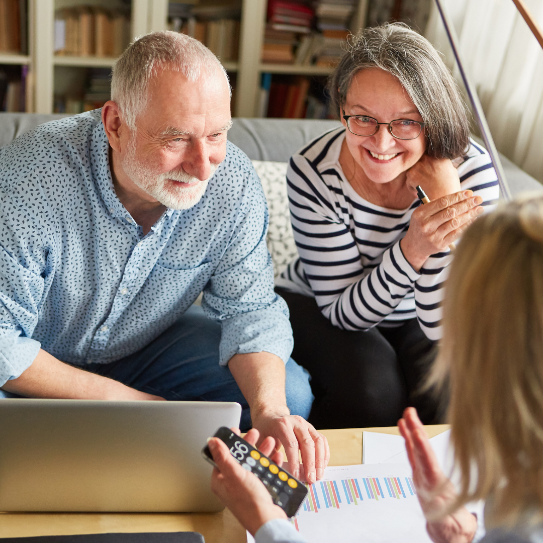 Retired people planning their finances with a financial planner.